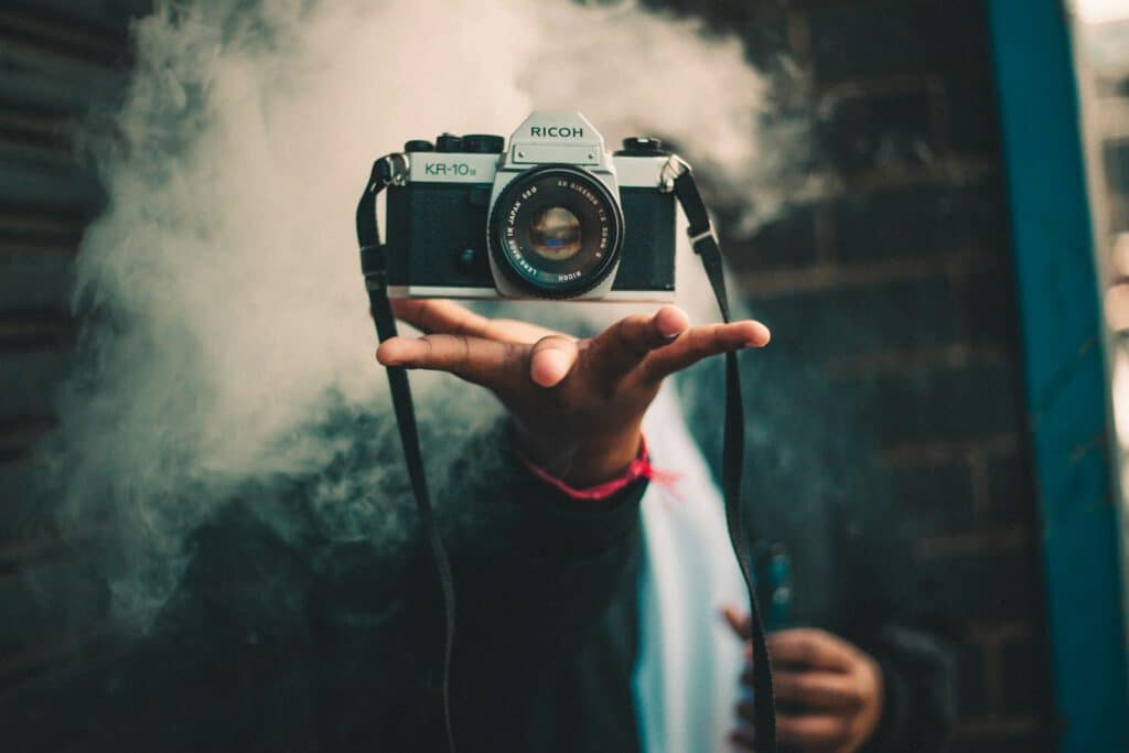 person catching Ricoh DSLR camera
