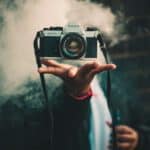 person catching Ricoh DSLR camera