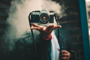 person catching Ricoh DSLR camera